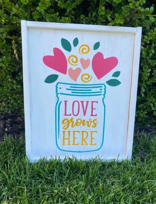 Love grows here with jar and heart flowers