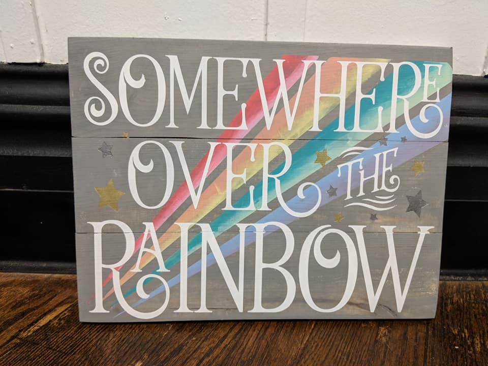 Somewhere over the rainbow with stars and rainbow in background
