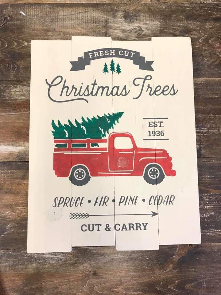 Fresh cut Christmas trees with truck